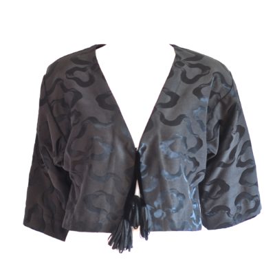 Cropped black brocade jacket with tasselled front tie