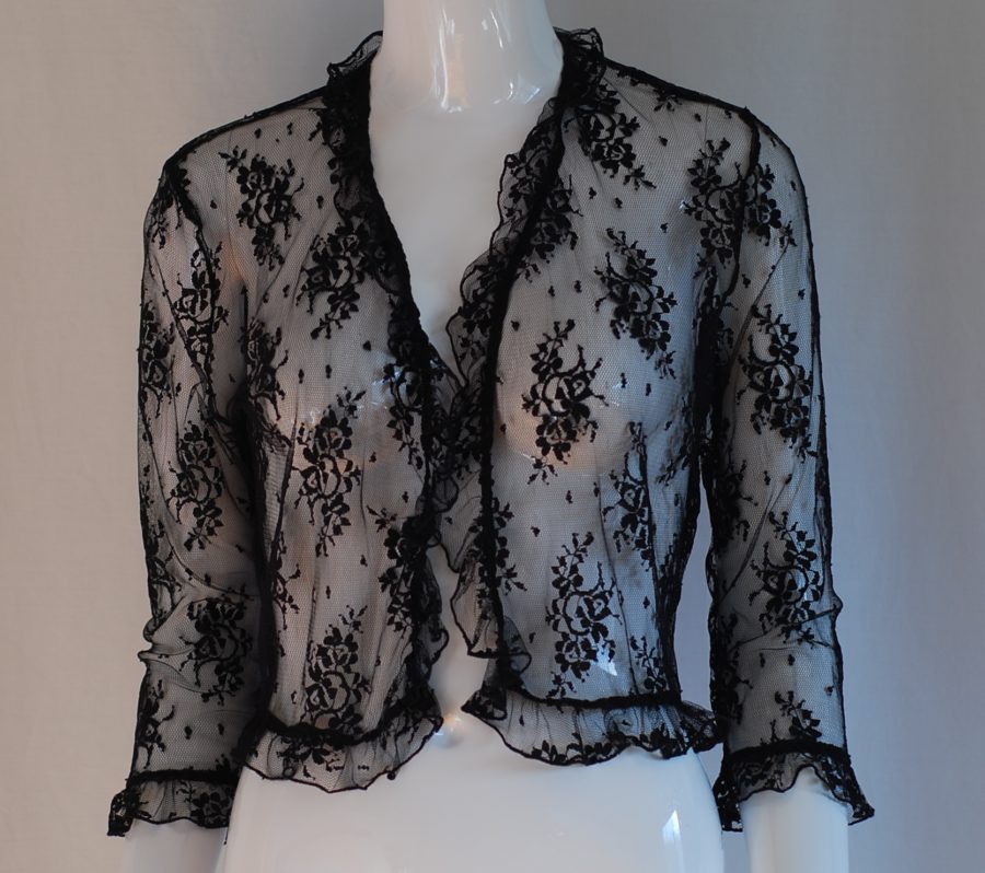 Sheer black lace blouse with ruffled trim and open front