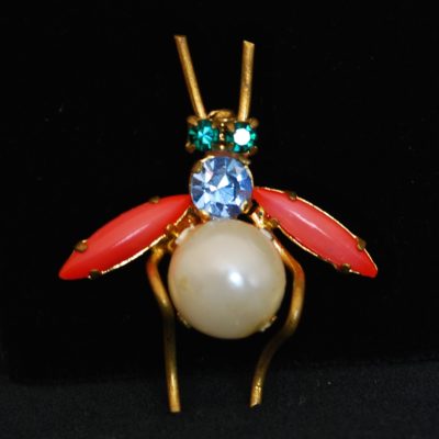 Vintage pin with rhinestone eyes, a resin pearl belly, and coral wings Product J191y