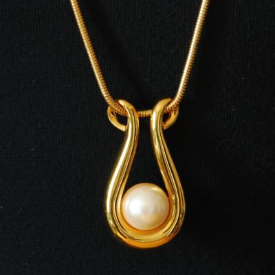 Monet long gold tone necklace with resin pearl pendant