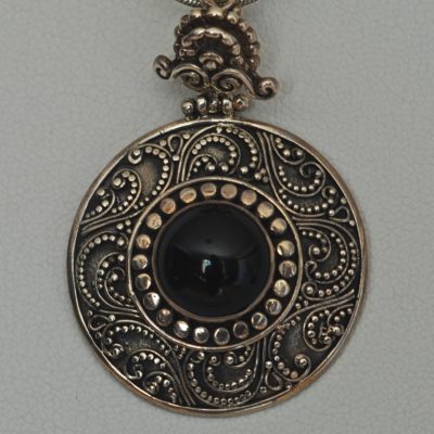 Onyx and sterling silver ornate artisan pendant wit an onyx centre