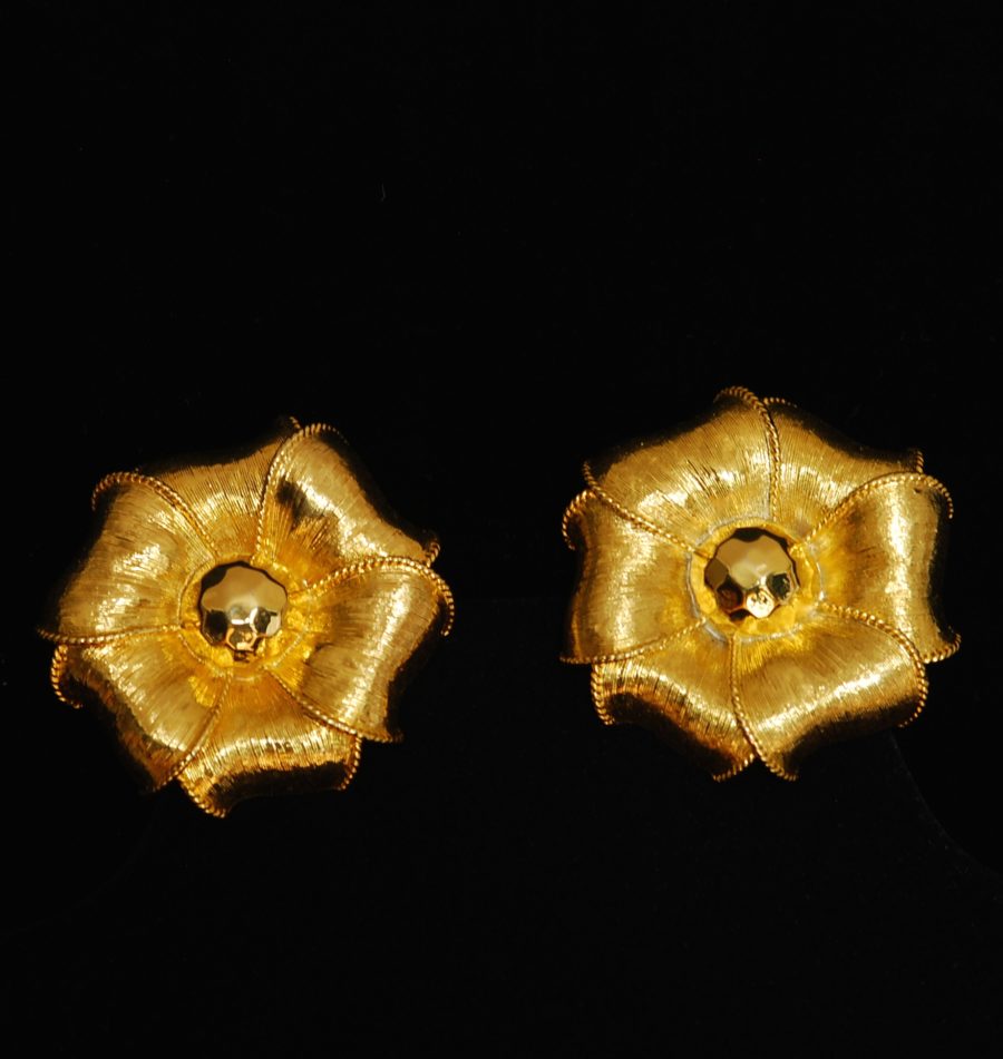 Givenchy gold tone flower shaped ear clips made of textured metal, signed on the back