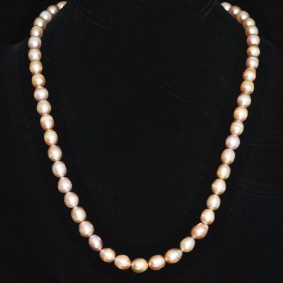 A Single Strand Of Pale Pink Semi Baroque Pearls With Silver Tone Clasp